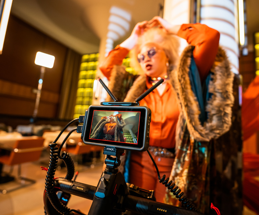 Closeup of Atomos monitor and camera filming a woman in a restaurant